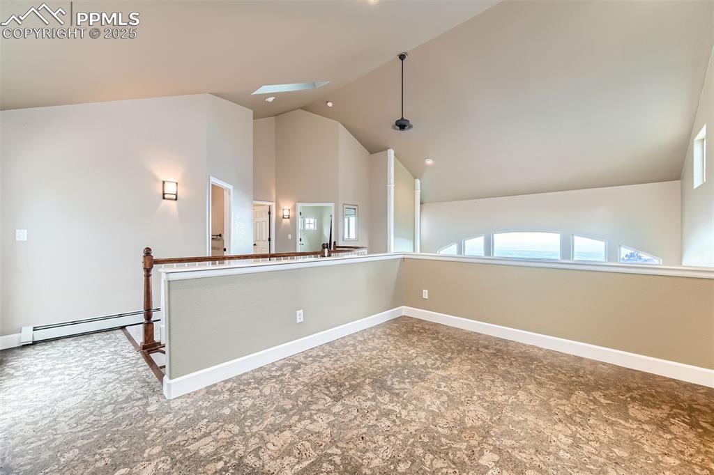 Image 29 of 35: Loft area that exits to rear of home, complete with cork floors, a skylight
