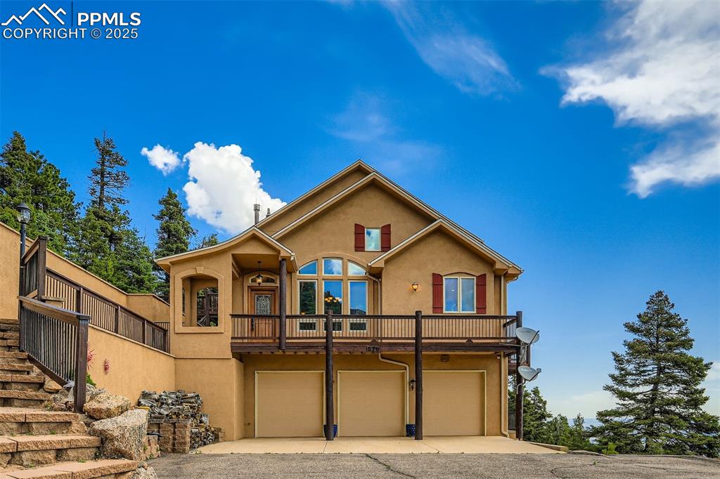Image 3 of 27: View of front of home featuring stucco siding, concrete driveway, and an at