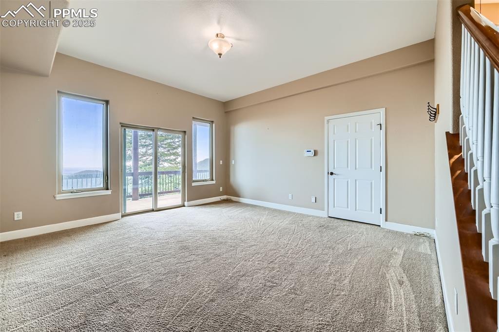 Image 31 of 35: Family room with sliding glass door exiting to a covered porch