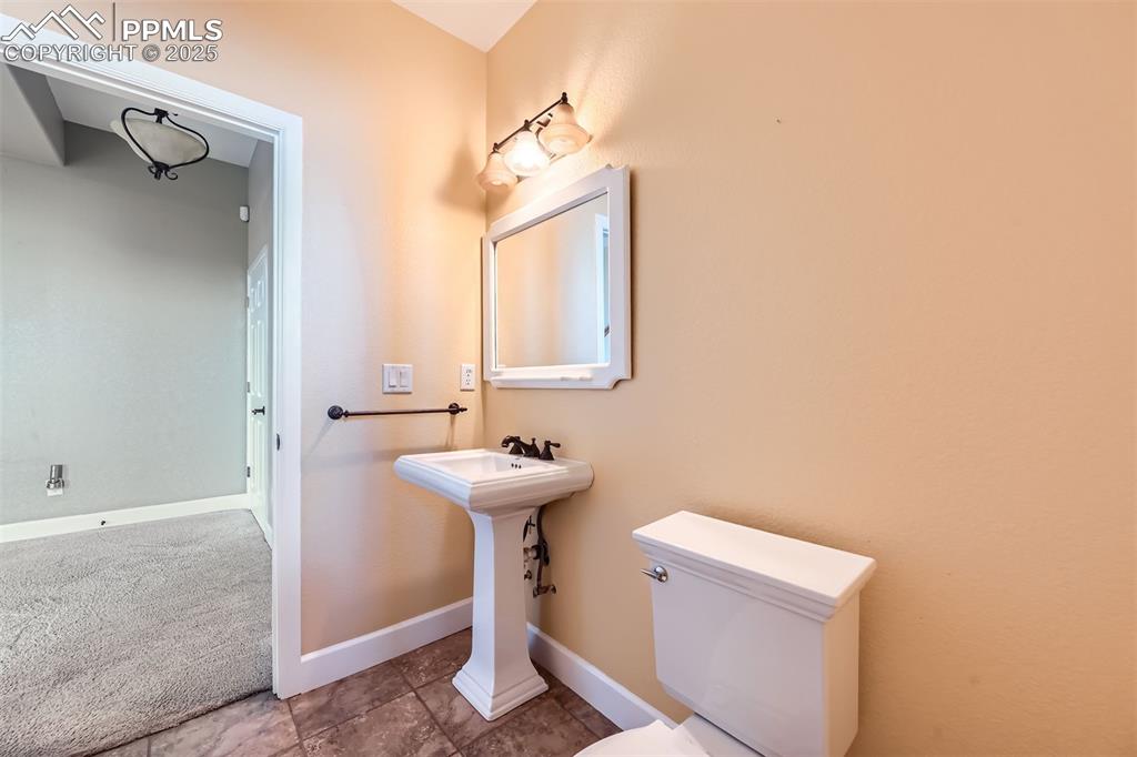 Image 32 of 35: Full bathroom with pedestal sink