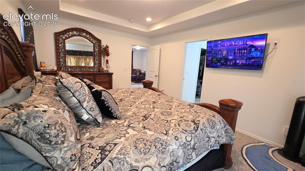 Image 17 of 48: Recessed lighting with a tray ceiling and neutral-toned walls