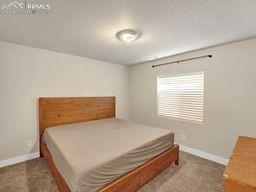 Image 18 of 26: Bedroom featuring baseboards