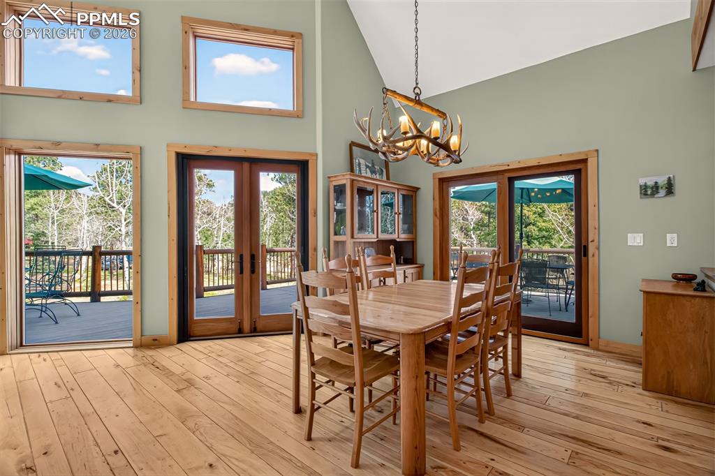 Image 10 of 48: Open concept great room with vaulted ceilings, a walk out to wrap around de