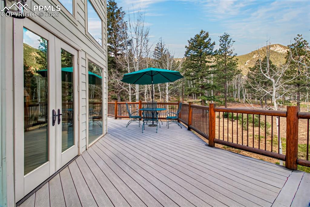 Image 12 of 48: Wrap around deck off great room