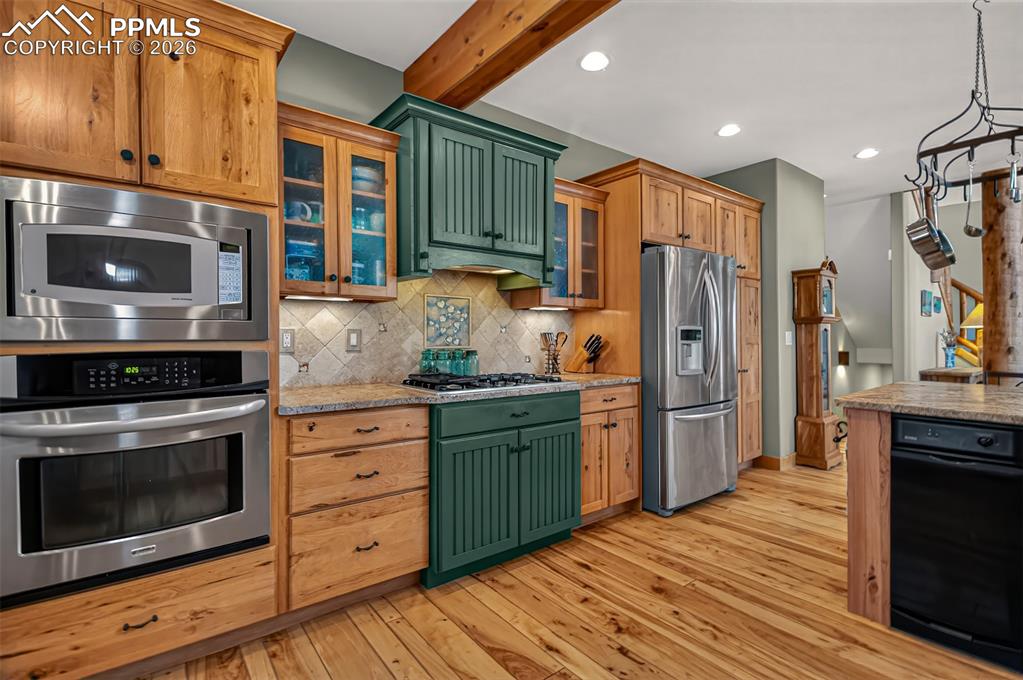 Image 14 of 48: Open concept dining room with knotty pecan flooring, a walk to to wrap arou