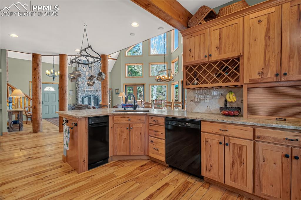 Image 15 of 48: Open concept dining room with knotty pecan flooring, a walk to to wrap arou