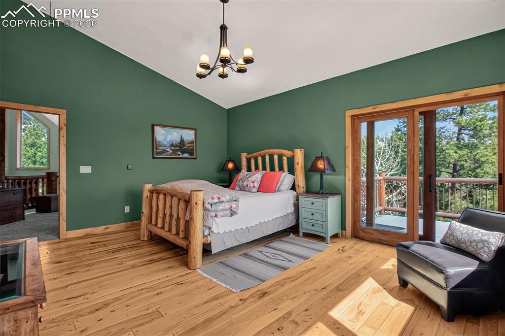 Image 28 of 48: Primary bedroom on the upper level with knotty pecan flooring, built in she