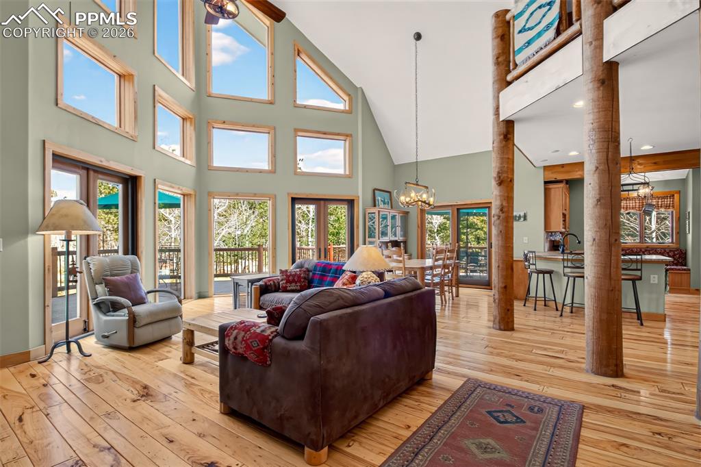 Image 3 of 48: Open concept great room with vaulted ceilings, a walk out to wrap around de