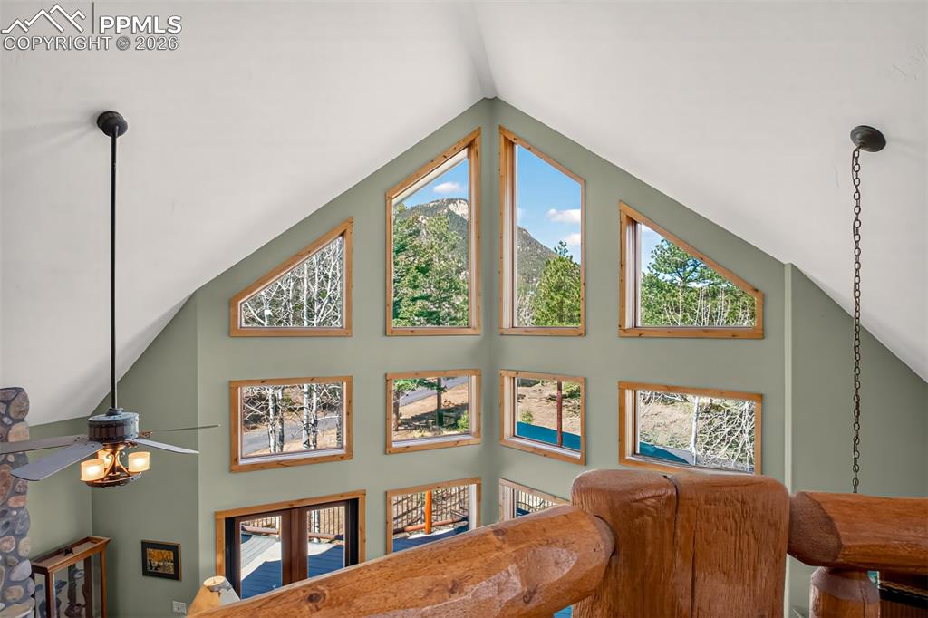 Image 32 of 48: Primary bedroom on the upper level with knotty pecan flooring, built in she