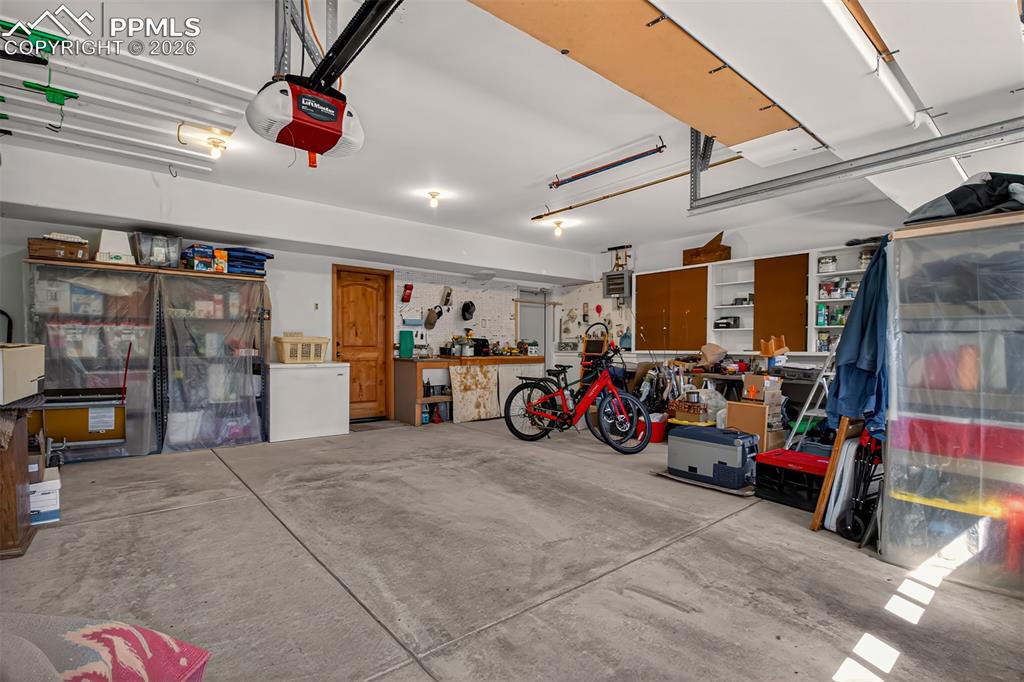 Image 40 of 48: Recreation room on the lower level with a murphy bed, 3/4 bathroom, a pelle