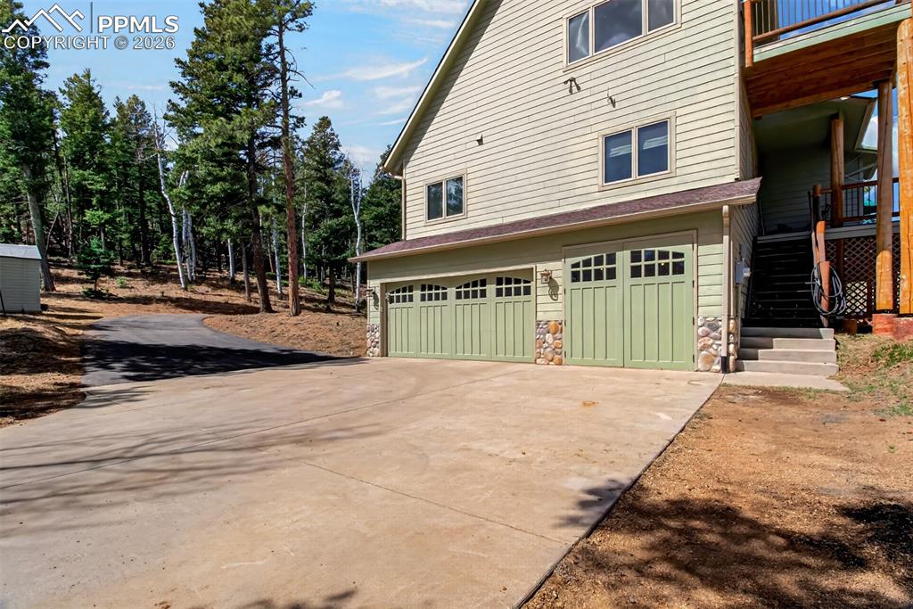 Image 42 of 48: 3/4 bathroom on the lower level with a copper sink surrounded by a granite 