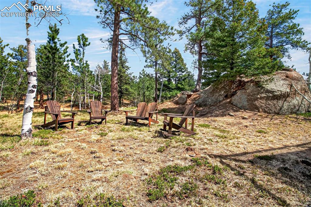 Image 44 of 48: 3 car heated garage with utility sink, attached utility room, work bench an