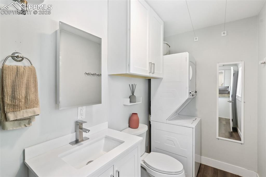 Image 16 of 31: 1/2 bathroom with laundry room off of kitchen