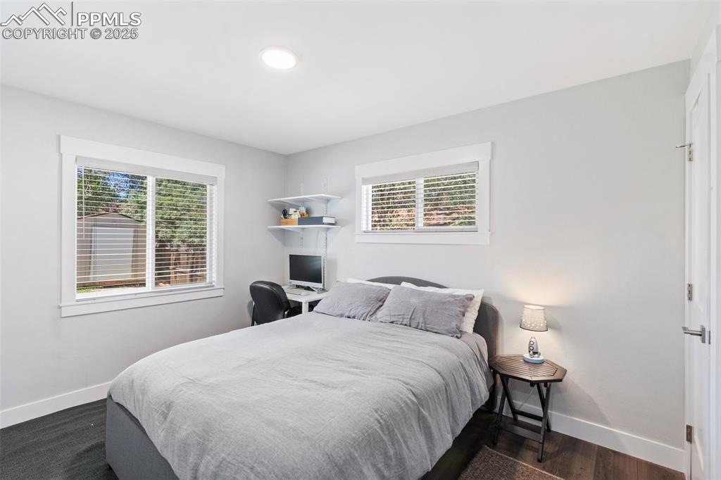 Image 20 of 31: Bedroom featuring baseboards and dark wood-type flooring