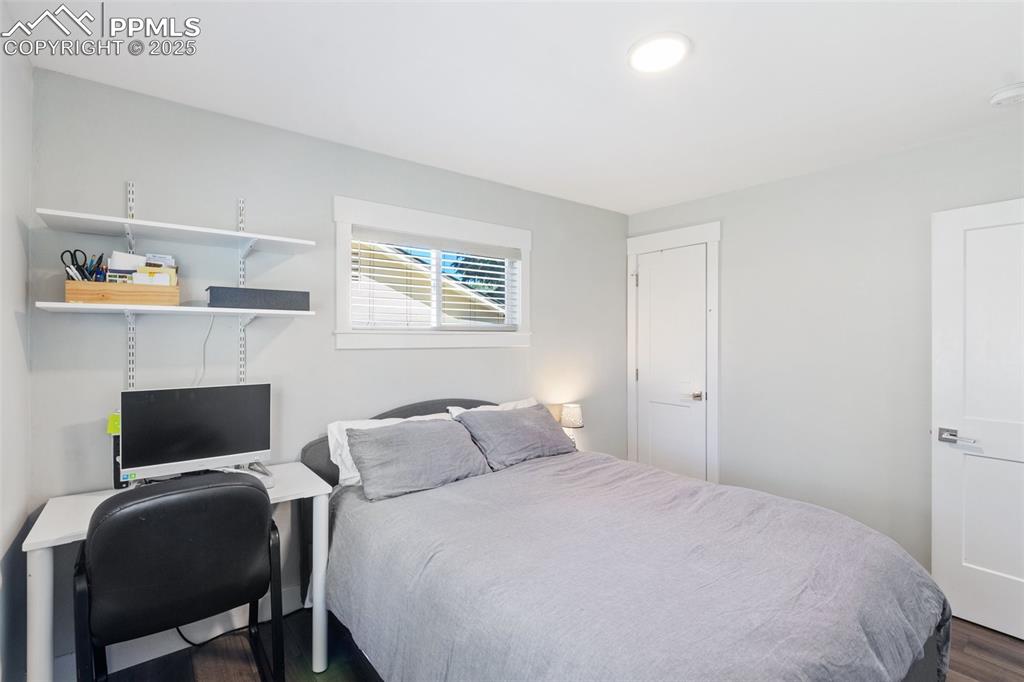 Image 21 of 31: Bedroom featuring dark wood-type flooring and an office area