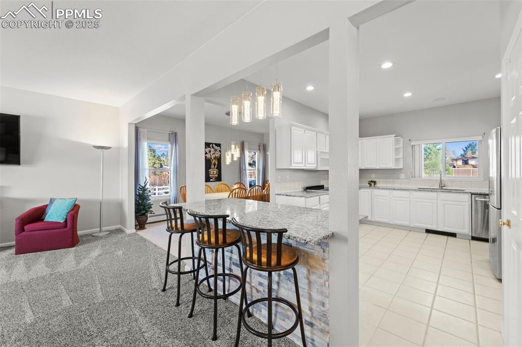 Image 9 of 47: 3 seat breakfast bar with open concept layout!