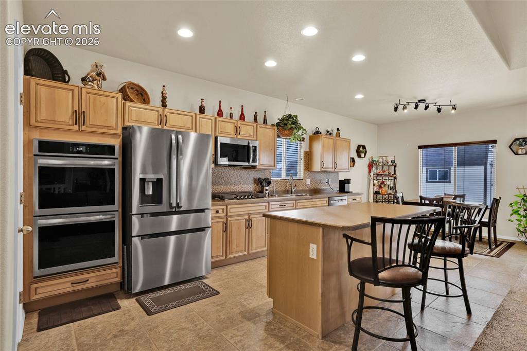Image 13 of 50: Double oven, gas cooktop, and pantry