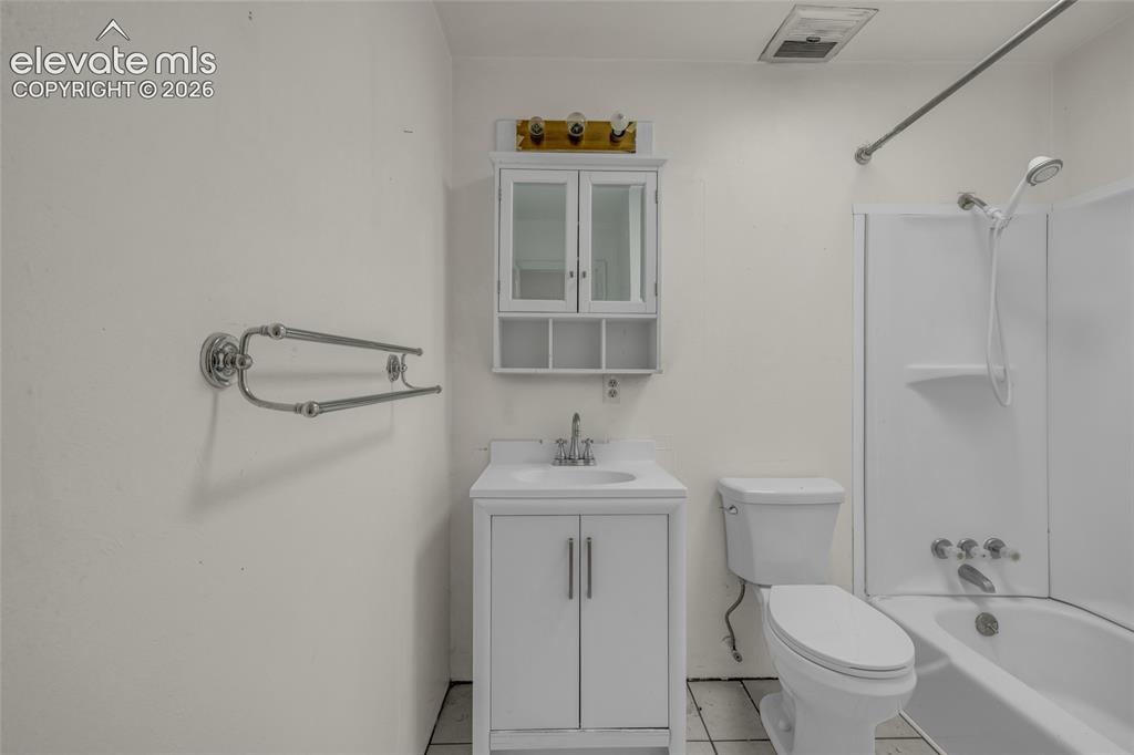 Image 12 of 25: White vanity with integrated sink, coordinating wall-mounted medicine cabin