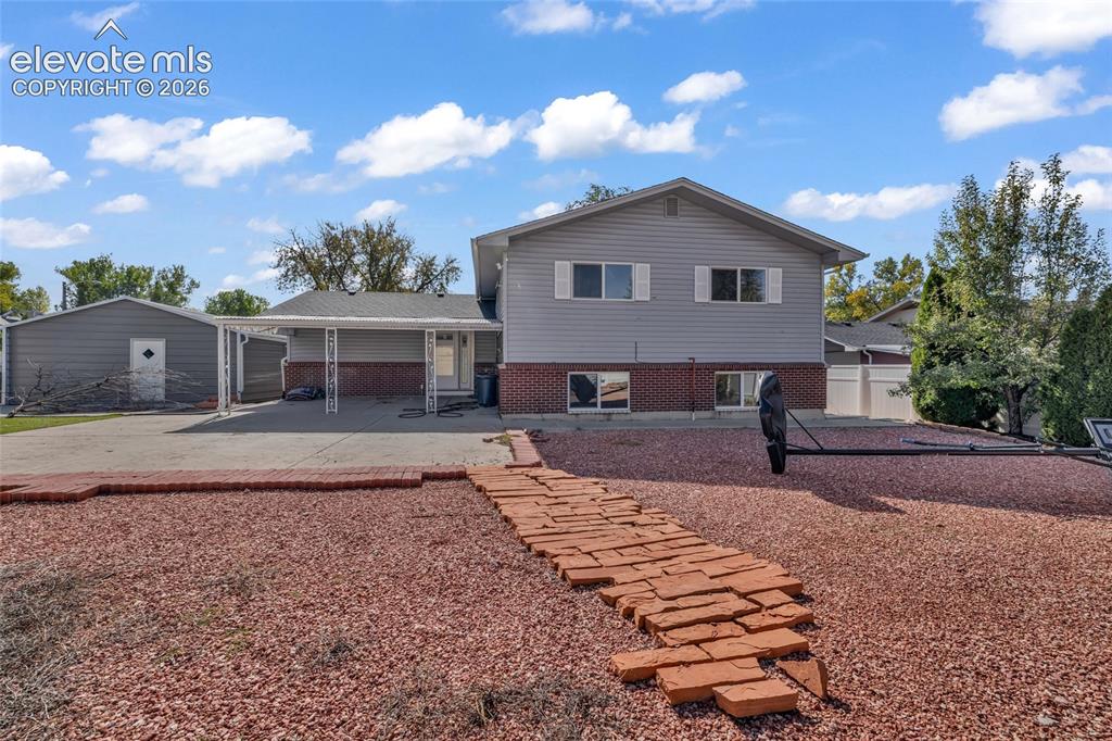 Image 25 of 25: Split-level residence featuring gray siding and brick accents