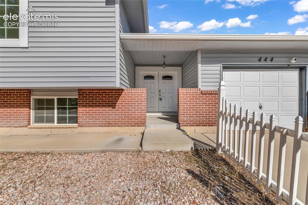 Image 4 of 25: Brick and siding exterior with a two-car garage
