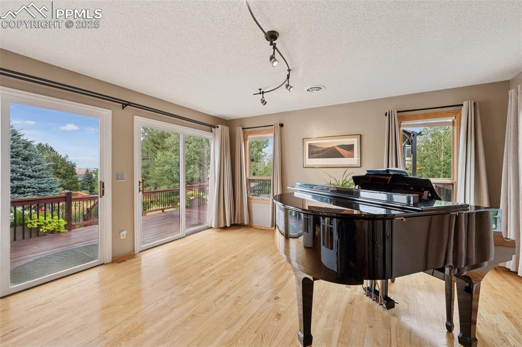 Image 18 of 50: Main Floor Sunroom with Wal Out To Huge Back Deck