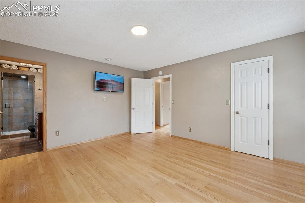 Image 21 of 50: Upper Level Primary Bedroom View Towards Primary Bathroom