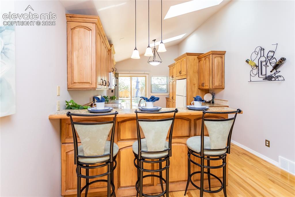 Image 11 of 48: A generous peninsula provides casual seating and creates the perfect gather