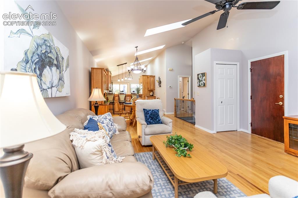 Image 16 of 48: The adjacent living room is equally impressive, where vaulted ceilings and 