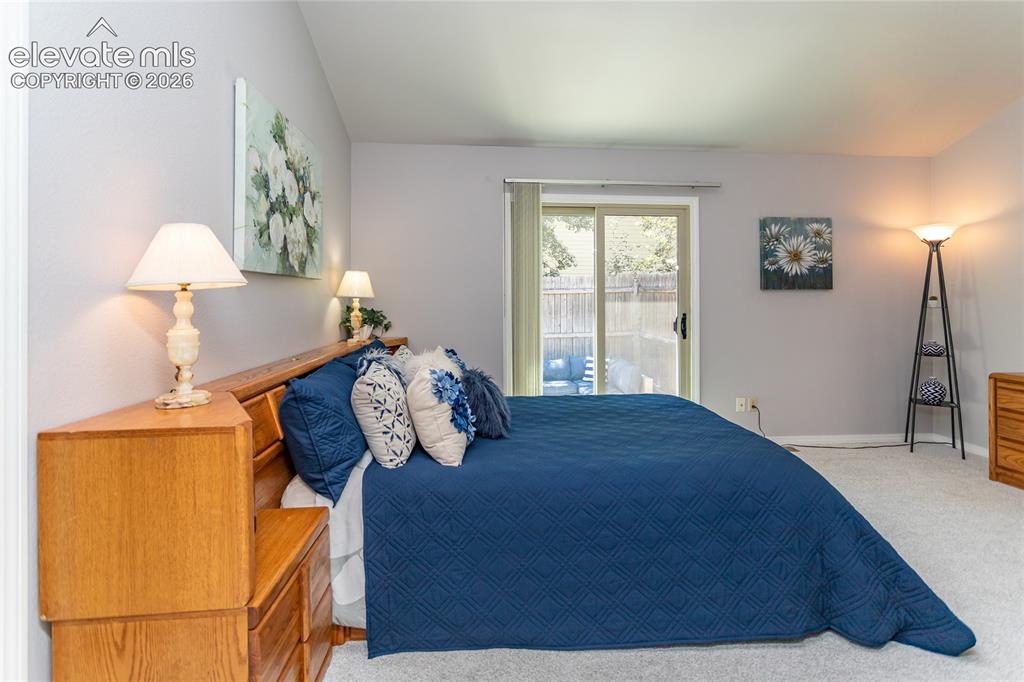 Image 22 of 48: Room featuring a vaulted ceiling and light-colored carpeting