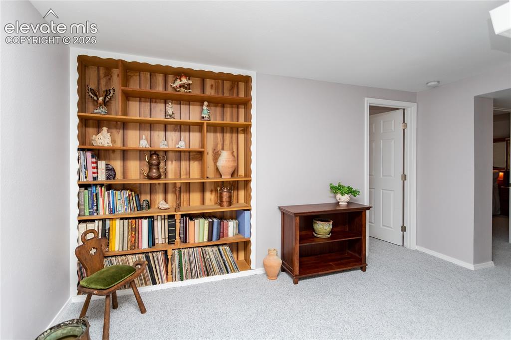 Image 33 of 48: Built-in wood shelving with scalloped trim, light gray wall paint, light-co