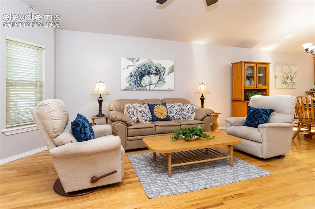 Image 4 of 48: Living space featuring wood-finish flooring, light-toned walls, and plenty 
