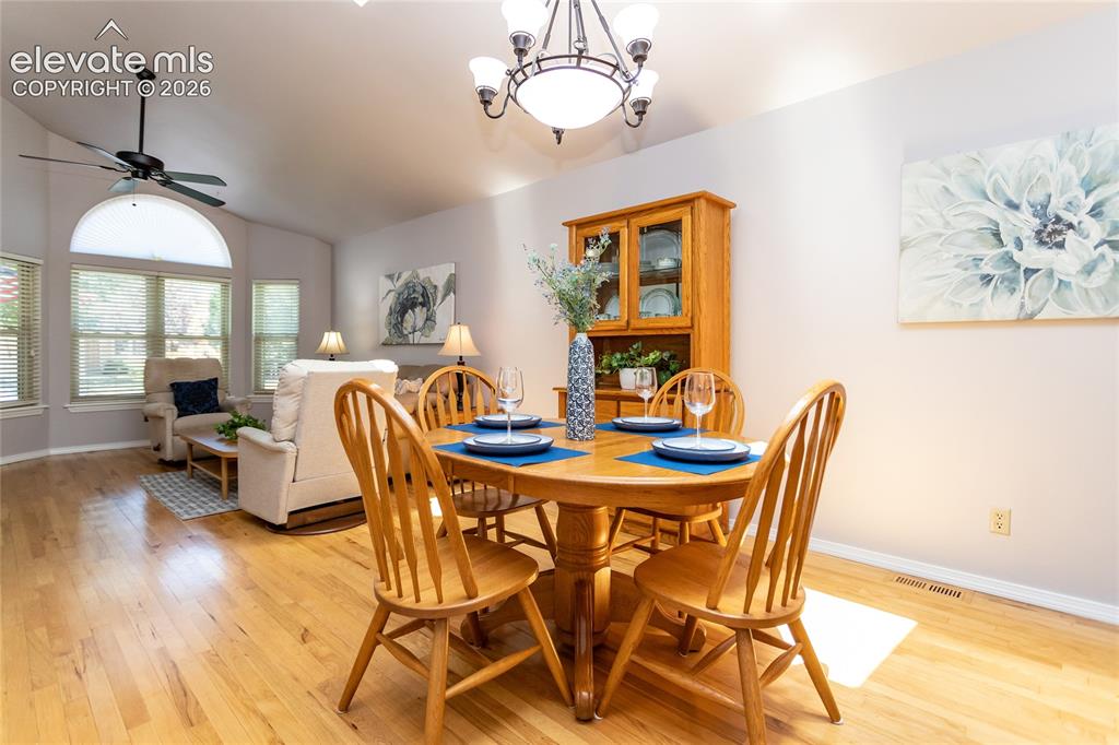 Image 8 of 48: Open-concept dining area featuring wood-finish flooring