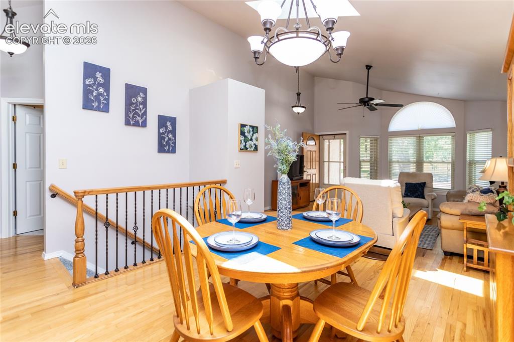 Image 9 of 48: Open-concept dining area featuring wood-finish flooring, a contemporary cha