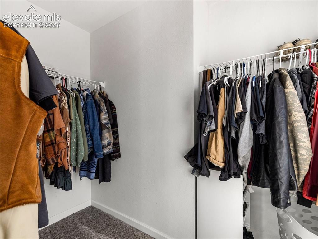 Image 13 of 27: Walk in closet in the primary
