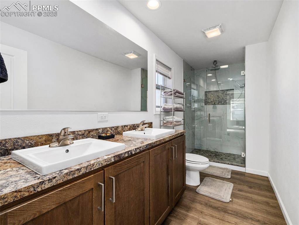 Image 15 of 25: Double vanity with custom tile shower