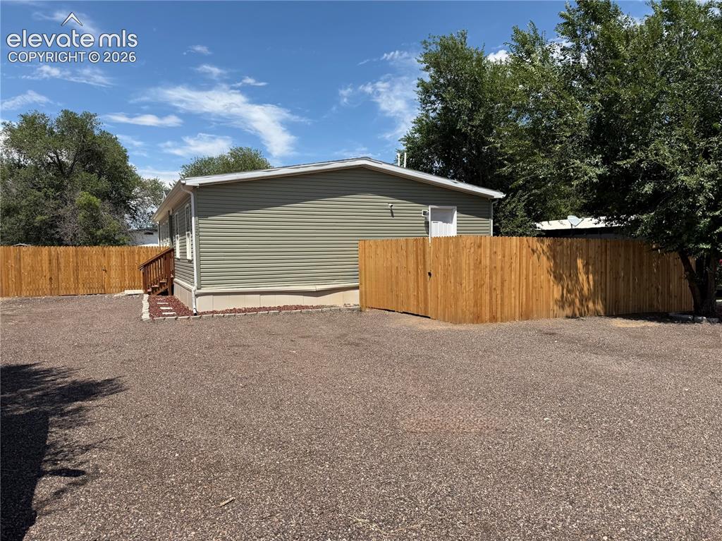 Image 3 of 27: Seller has added a full privacy fence that extends from the front door all