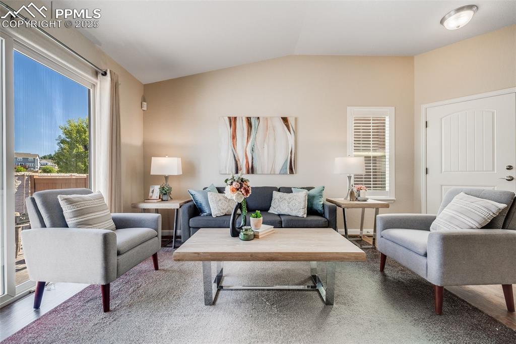 Image 7 of 44: Living room featuring lofted ceiling and wood finished floors