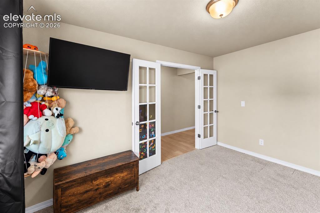 Image 5 of 26: Office with French doors- currently a play room!