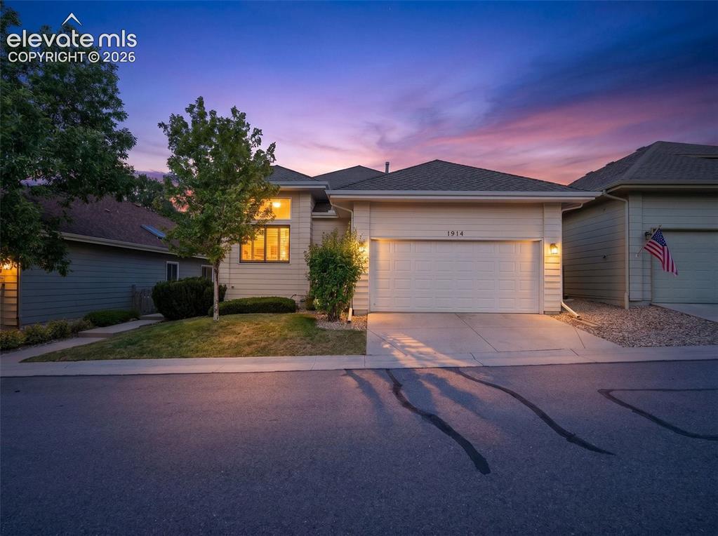 Image 3 of 46: Ranch-style exterior featuring a two-car garage, concrete driveway, and fro