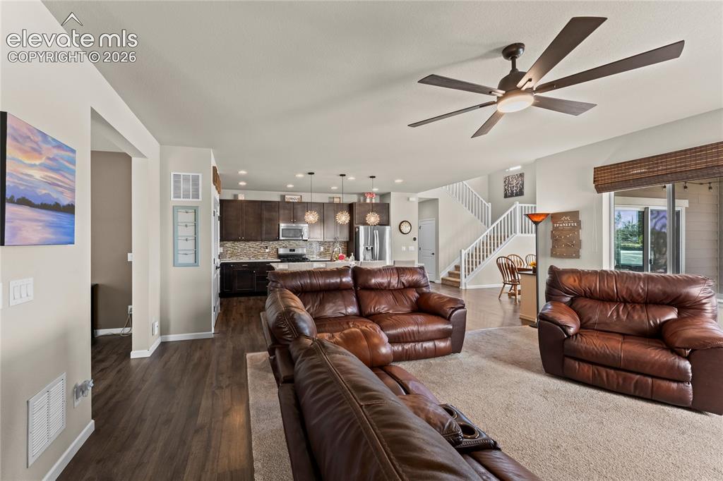 Image 10 of 41: Spacious den with lots of windows and beautiful luxury vinyl plank flooring