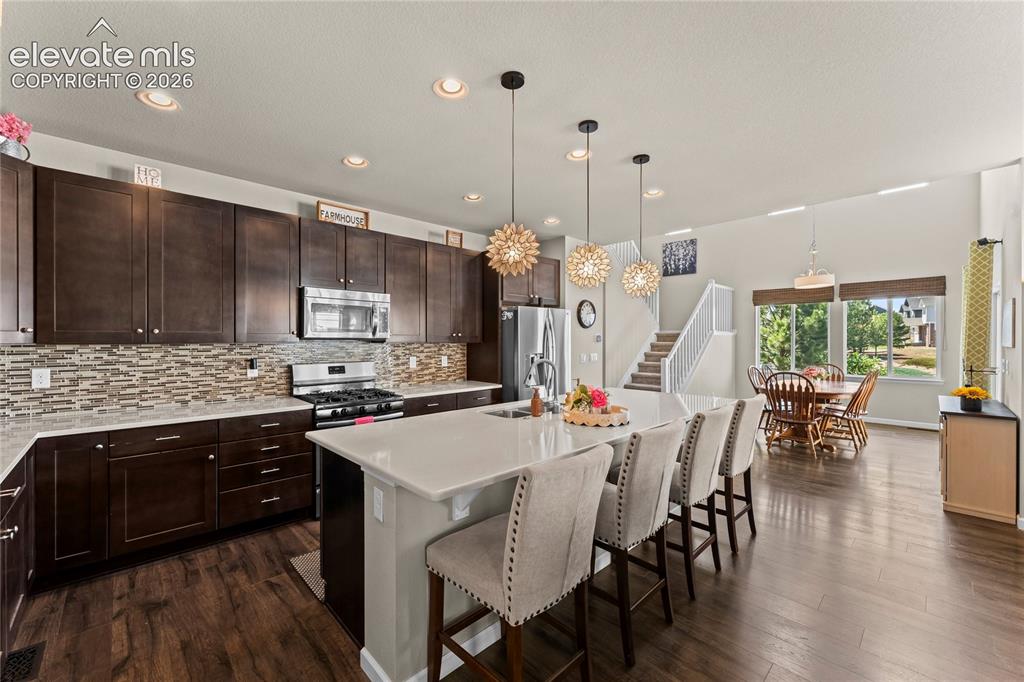 Image 11 of 49: Beautiful kitchen with upgraded cabinetry, quartz countertops and backsplas