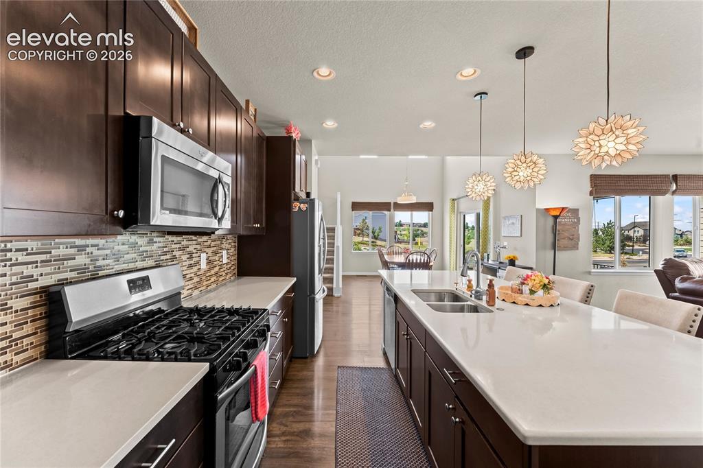 Image 3 of 41: Beautiful kitchen with upgraded cabinetry, quartz countertops, lovely backs