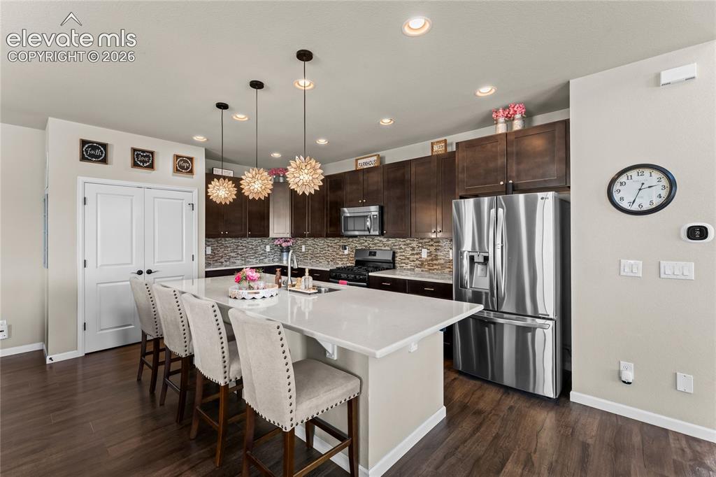 Image 4 of 41: View of the kitchen showing the abundant counterspace and massive gas stove