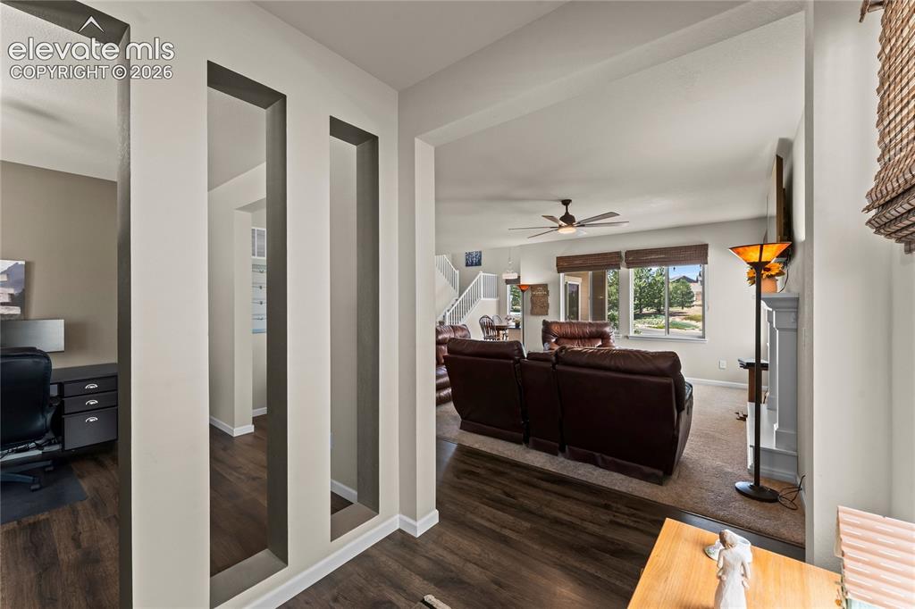 Image 8 of 41: Living Room surrounded by luxury vinyl plank flooring, carpeting in the cen