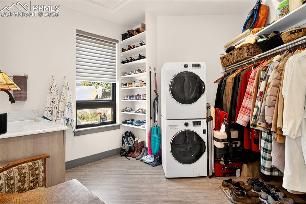 Image 46 of 50: Mud room with laundry, utility sink, closet and storage space