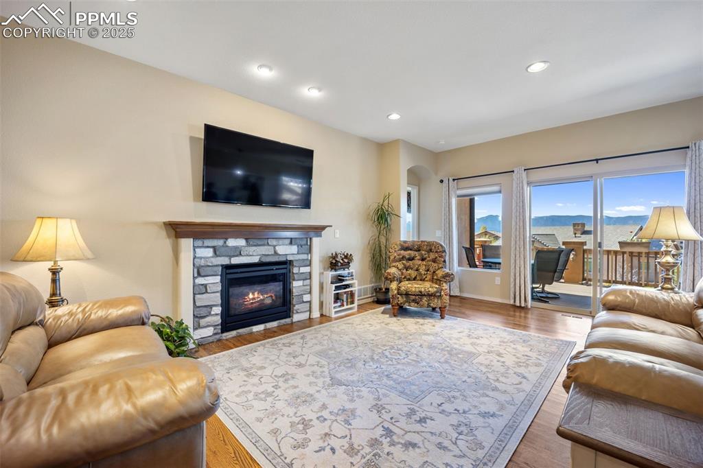 Image 11 of 50: Living room featuring arched walkways, a fireplace, recessed lighting, and 