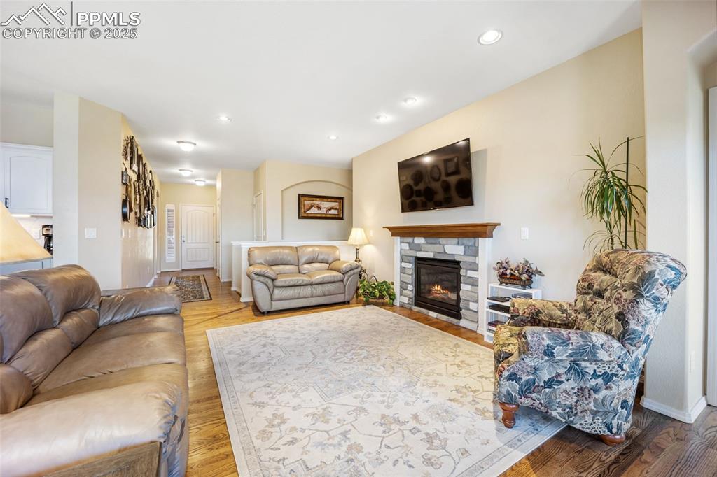 Image 12 of 50: Living room with a fireplace, recessed lighting, and light wood-type floori