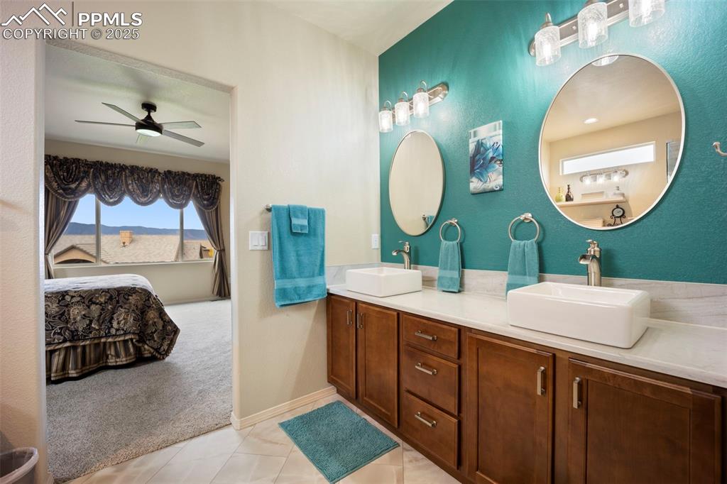 Image 26 of 50: Bathroom with light carpet, light tile patterned floors, double vanity, a c