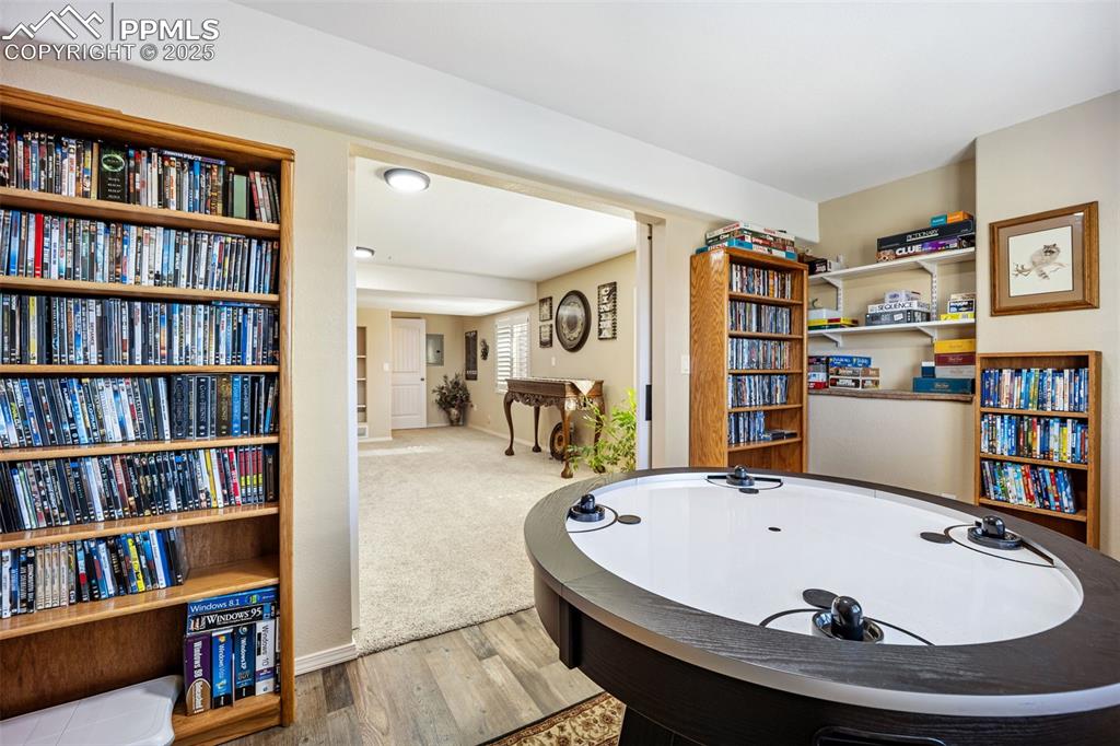 Image 32 of 50: Game room with wood finished floors