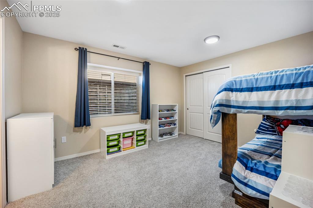 Image 38 of 50: Bedroom featuring light carpet and a closet
